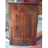 A George III mahogany/oak hanging bowfront corner cupboard,