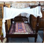 A solid carved teak Lombok furniture 'Kearton' model colonial style kingsize four poster bed c/w