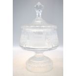 A cut glass stem bowl on cylindrical foot with domed cover and finial, 42 cm.