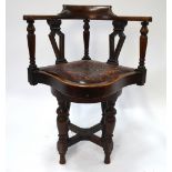 A late 19th/early 20th century mahogany swivel elbow chair,