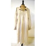 An early 1900s unbleached linen farm workers smock with smocking and embroidery to bib,