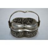 A white metal incense, or other, burner with looped handle, decorated with narrative scenes,