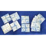 A set of Eleven, English glazed tiles; each one with a floral design in mottled blue,