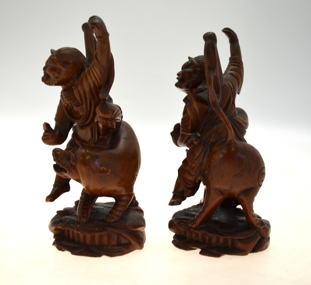 A pair of Chinese carved hardwood figures of ascetic Immortals riding a fabulous animal, 20 cm high, - Image 3 of 5