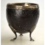 A Georgian silver-mounted coconut cup, unmarked, the lining set with a George III sixpence,