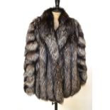 A black/grey/white Canadian fox fur jacket with black silk satin lining,