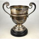 A silver trophy cup with twin scroll handles, on stemmed foot, Harrison Brothers & Howson,