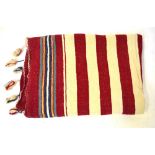 Three early 1900s cream ground Moroccan woven wool blankets with red striping and tassels to ends,