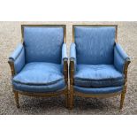 A pair of gilt framed blue satin upholstered salon armchairs, bears trade plate for W Charles Tozer,