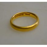 A 22ct yellow gold court style wedding band, approx 5 g,