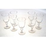 A set of seven 19th century wine glasses with a round funnel bowl,