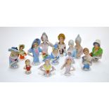 Thirteen pin cushion/tea cosy continental porcelain half figures (13)