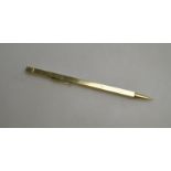 A square sectioned propelling pencil extending to form a 12" ruler, pale yellow metal stamped 14k,