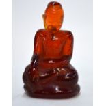 A miniature amber figure of Shakyamuni, The Historical Buddha,