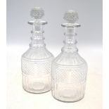 Two pairs of Georgian cut glass mallet decanters and stoppers; each one of cylindrical,