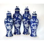 A Chinese garniture of four vases and domed covers;