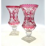 A pair of large Bohemian flash glass vases each raised on spherical facetted stem and square