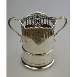 A cylindrical silver siphon stand with pierced top and twin handles, William Hutton & Sons Ltd,