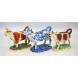 Two Victorian Staffordshire cow creamers and a Dutch Delft example (3) Condition Report