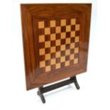 A folding low table with inlaid chessboard top