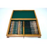 An oak-cased set of twelve epns kings pattern dessert forks to/w with six each table knives and tea