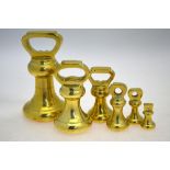 A set of six brass bell-weights,