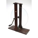 A mahogany framed and mounted circular plate glass disc rotating via a crank handle - for the
