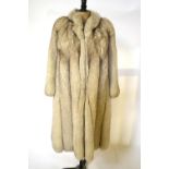 An Arctic fox fur full length coat, with neat collar and belled sleeves, ivory silk satin lining,