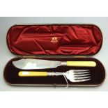 A late Victorian cased pair of silver fish servers with bright-cut blades and ivory handles,