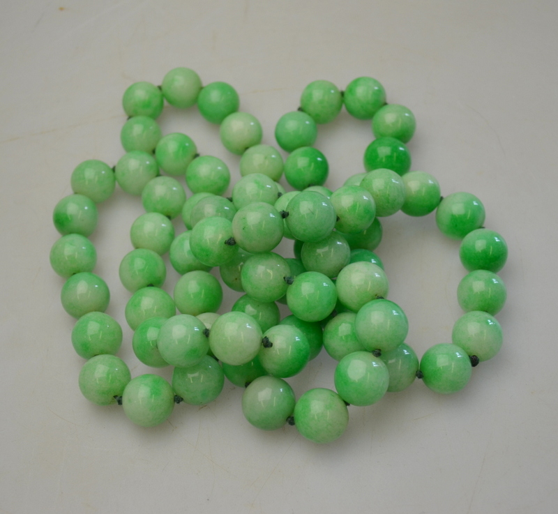 A long row of large dyed green stone beads. 72 beads, approximately 16mm diam.