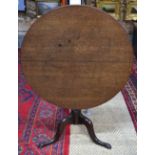 An 18th century provincial oak tripod supper table,