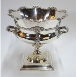 An electro plated punch-bowl with scrolling rim and twin handles,