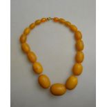 A row of graduated crazed amber beads,