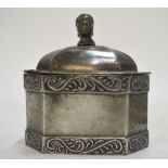 A 19th century lead tobacco box and cover of elongated octagonal form with African head finial and