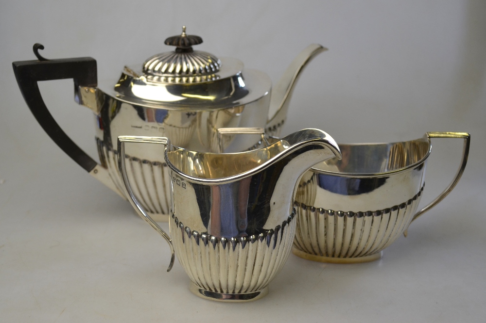 An oval half-reeded silver three-piece tea service, H V Pithey & Co, Birmingham 1911/12, 27.