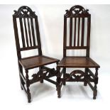 A pair of 17th/18th century North Italian fruitwood/walnut side chairs having moulded crests over