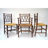 A set of seven faux bamboo oak framed rush seat dining chairs comprising a carver and six side