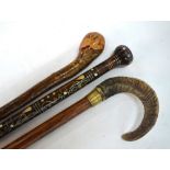 A long walking stick with sheep's horn handle,