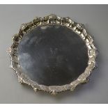 A silver letter salver in the Georgian manner, with shell and scroll moulded rim,