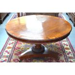 A Victorian crossbanded mahogany breakfast table, the circular tilt top with beaded edge and frieze,