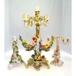 A Continental candlestick with two branches, decorated with two children sitting on a ledge,