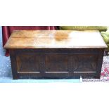 A late 17th/18th century oak coffer, the wide two plank top over a twin panel front,