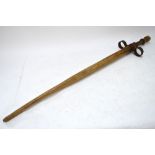 A vintage wood pogo-stick with wrought iron mounts