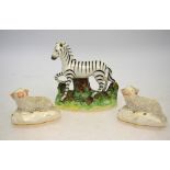 Victorian Staffordshire models, comprising: Zebra, 12 cm high, two recumbent sheep, 5.