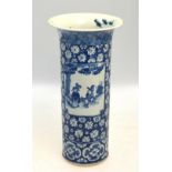 A blue and white cylindrical vase, decorated with a panel depicting a scholar,