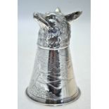 A silver stirrup cup with chased fox's head foot,