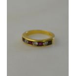 Ruby and diamond seven stone half eternity ring, four oval rubies and three diamonds, channel set,