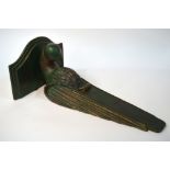 An Art Deco painted wood wall bracket, carved as a parrot,