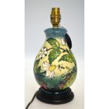 A Moorcroft table lamp base decorated with the 'Fruit Garden' pattern,