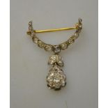 Diamond set crescent brooch with leaf and cluster drop,